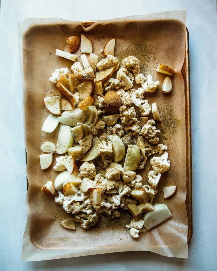 Overhead shot of vegetables on a baking sheet before they are about to be roasted.