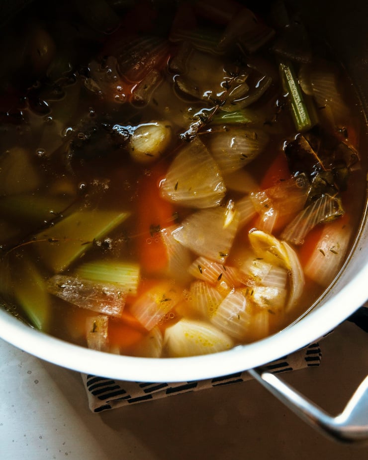 Image shows vegetable stock in a pot at an up close angle.