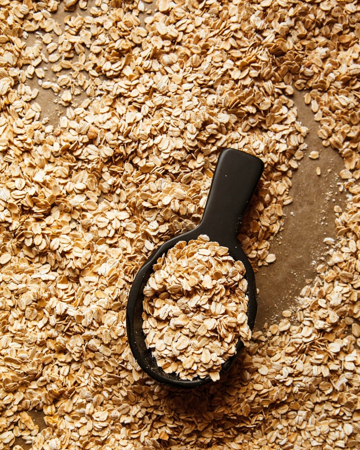 Overhead shot of toasted oats with a black scoop.