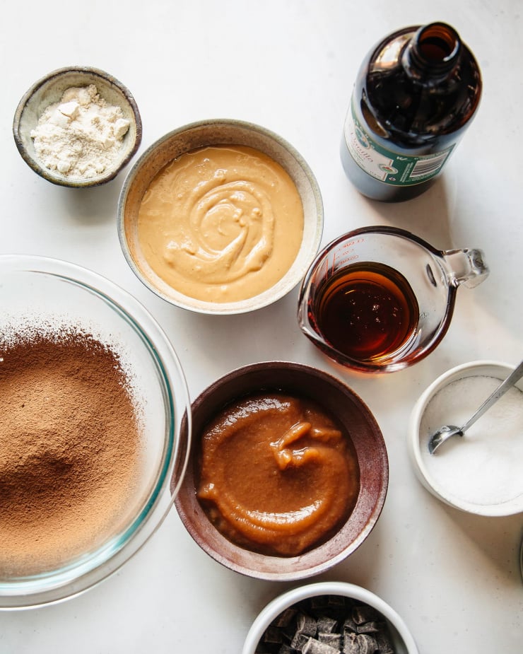 An overhead shot of the ingredients used to bake brownies, all in individual decorative bowls.