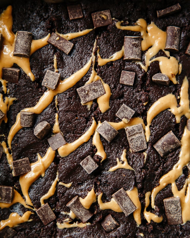 An up close shot of the top of the non-baked brownies with peanut butter swirls and chocolate chunks.