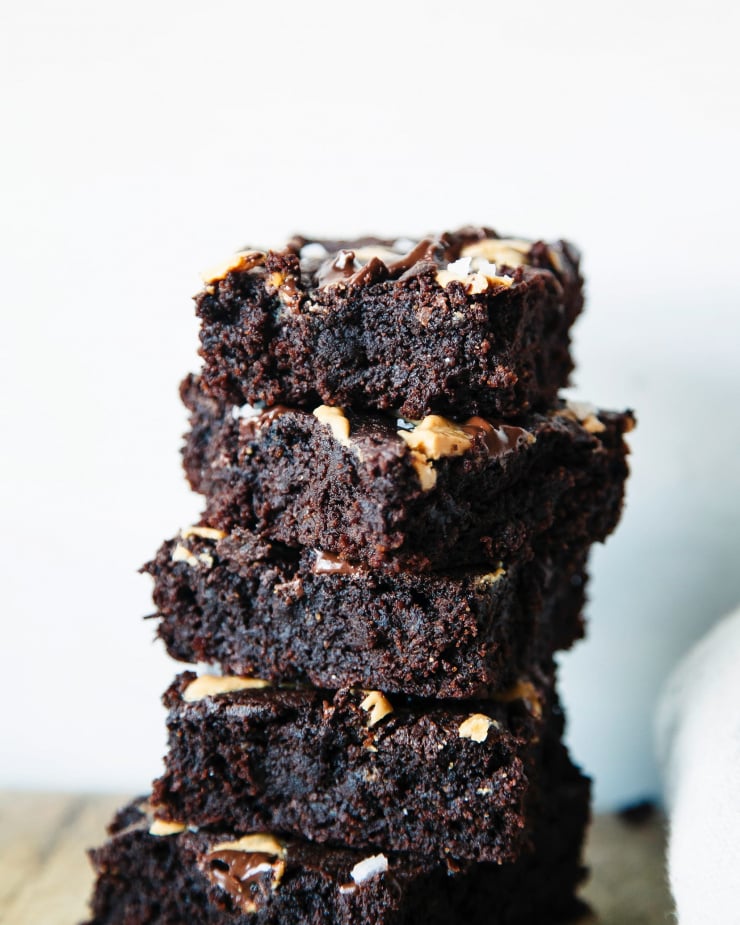 A head-on shot of fudgy brownies stacked on top of each other