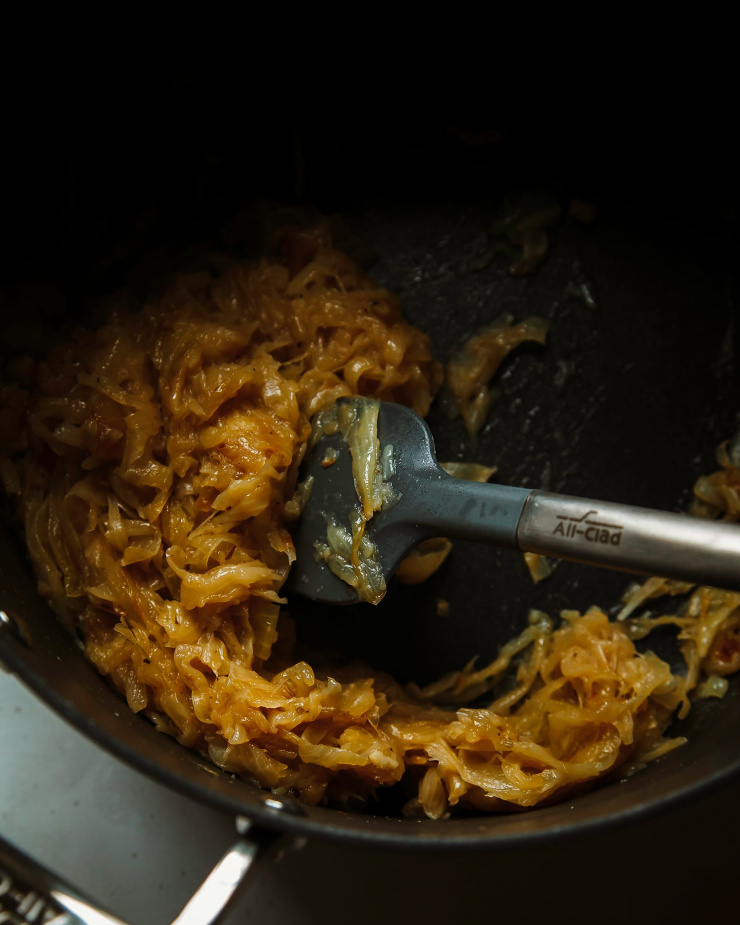 Image shows caramelized onions being stirred.