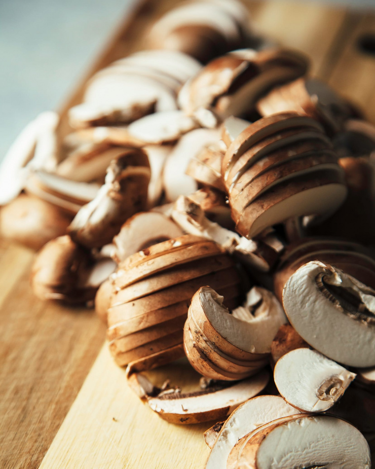 A 3/4 angle shot of some sliced mushrooms.