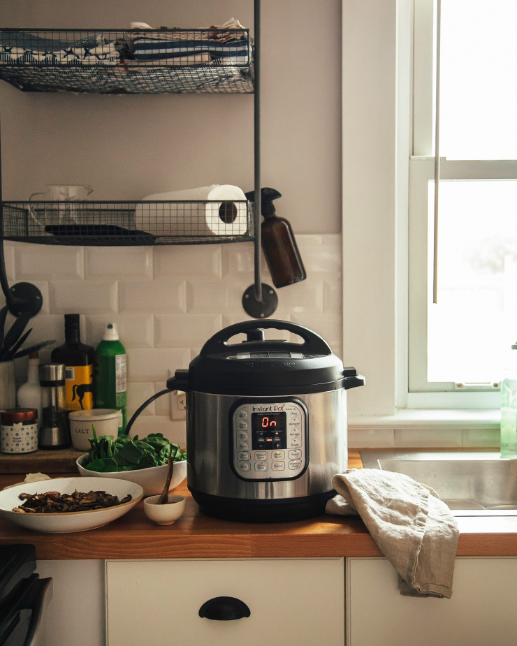 Image shows a kitchen scene with an Instant Pot on the counter.