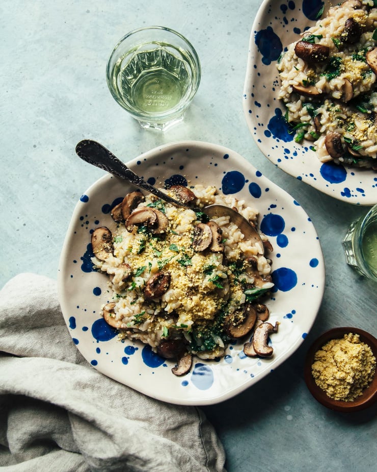 An overhead shot of vegan Instant Pot mushroom risotto in 2 serving bowls.