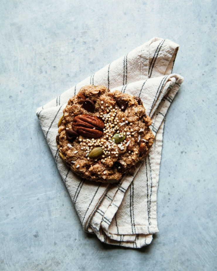 An overhead shot of a single cookie on a beige napkin.