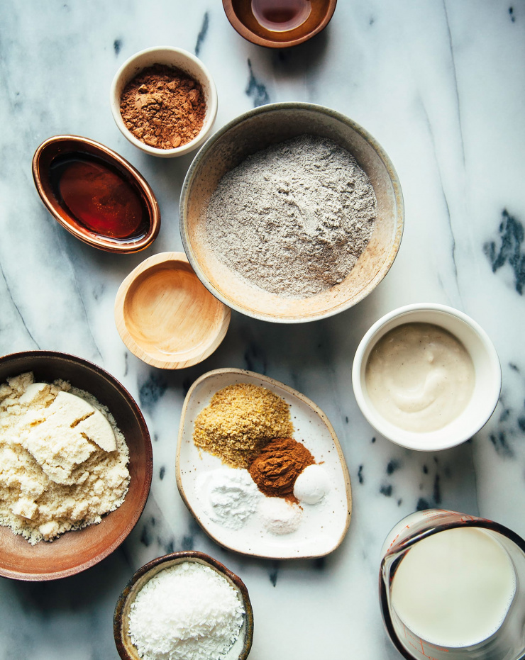 Overhead shot of ingredients measured out into small bowls on a marble background.