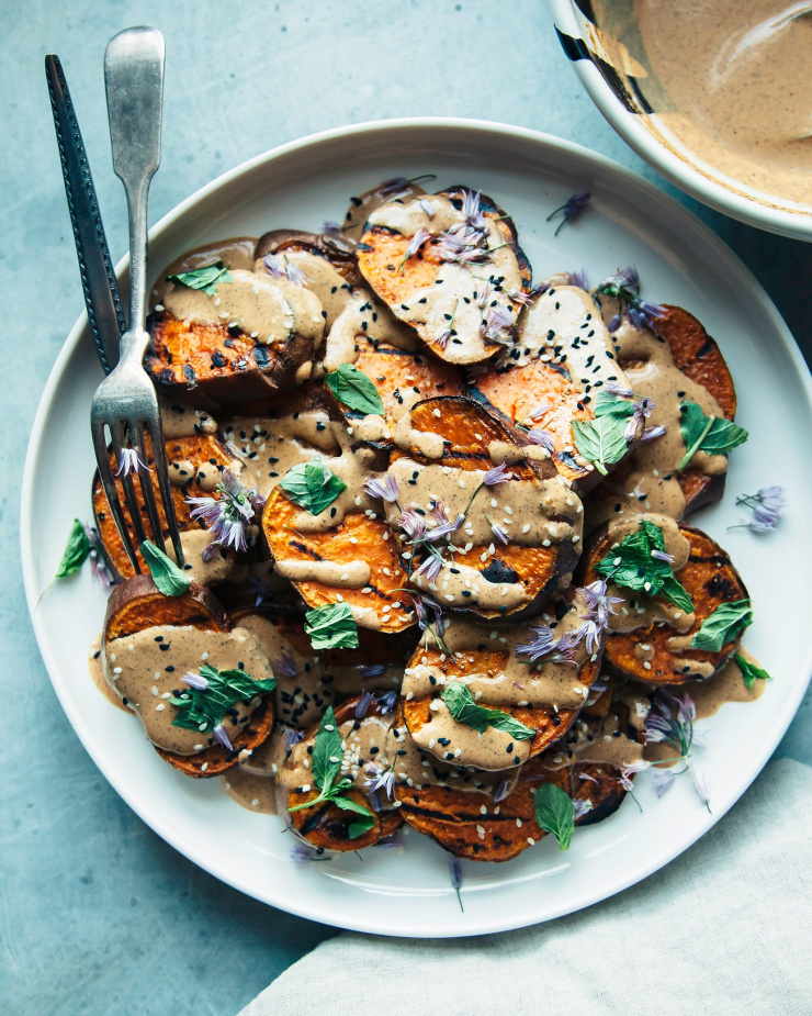 Overhead shot of grilled sweet potatoes with Chile lime tahini sauce.
