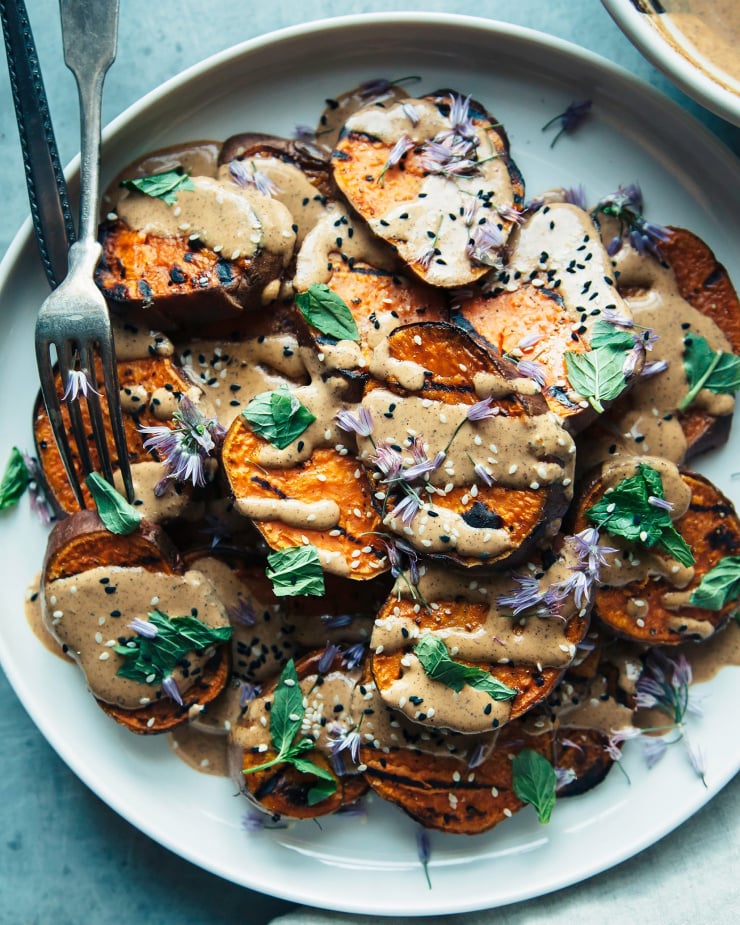 Overhead shot of grilled sweet potatoes with Chile lime tahini sauce.