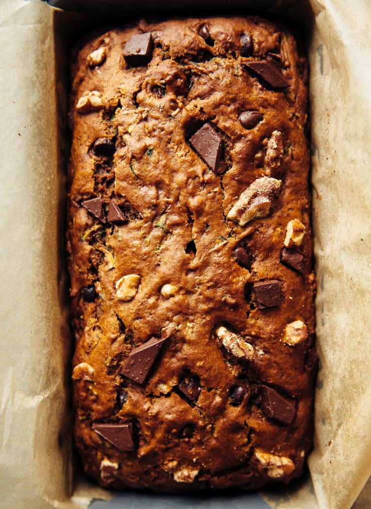 An up close, overhead shot shows the top of a baked zucchini bread.