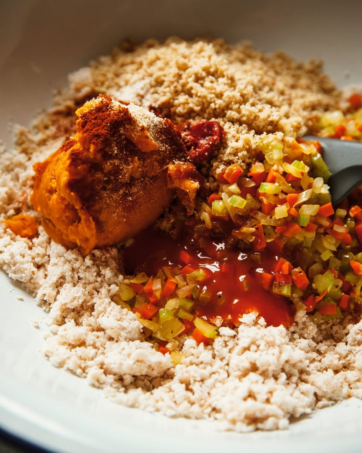 An up close shot of sweet potato puree, walnuts, white beans, and more, about to be mixed.