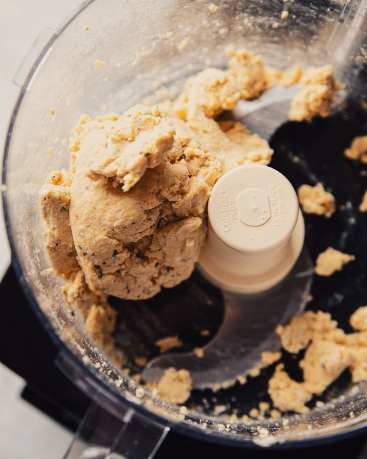 A ball of gluten-free galette dough in a food processor.