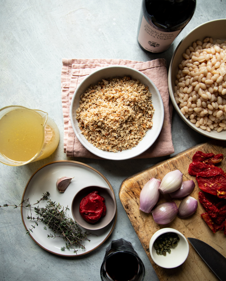 Overhead shot of ingredients on a light blue background with a light pink napkin. The lighting is moody.