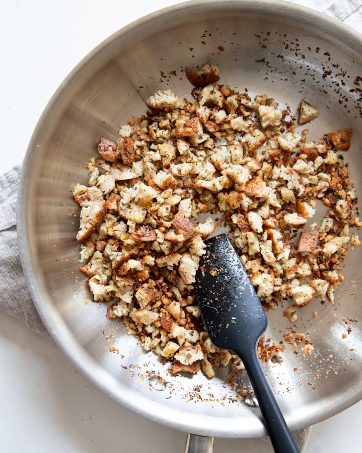 Image shows breadcrumbs being toasted in a sauté pan.