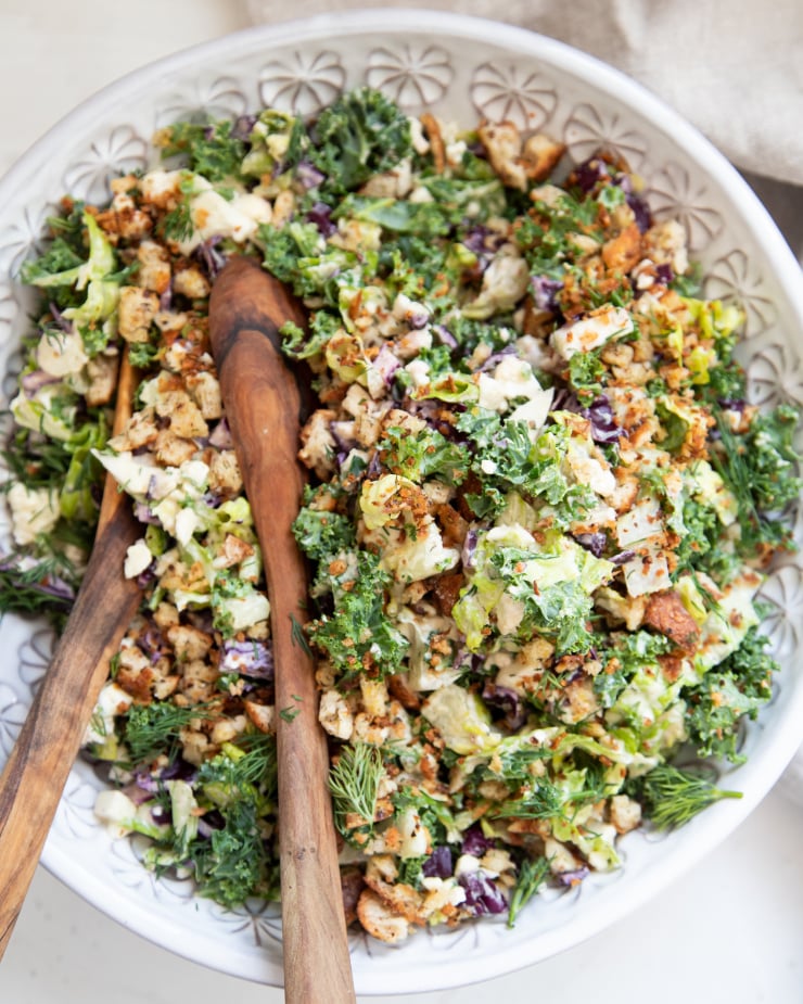 An overhead shot of a colourful chopped salad with creamy dressing.