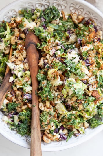 An overhead shot of a colourful chopped salad with creamy dressing.