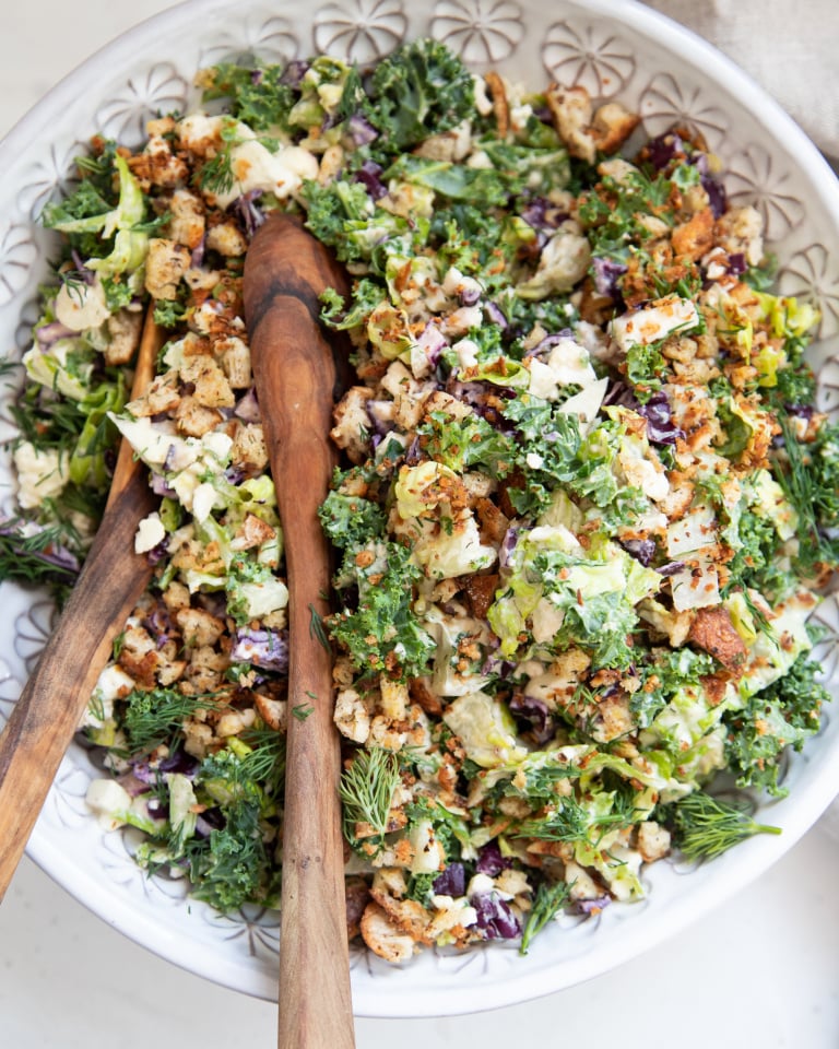 An overhead shot of a colourful chopped salad with creamy dressing.