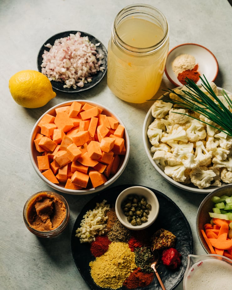 A slight 3/4 angle image of ingredients used in a vegan cauliflower and sweet potato chowder.