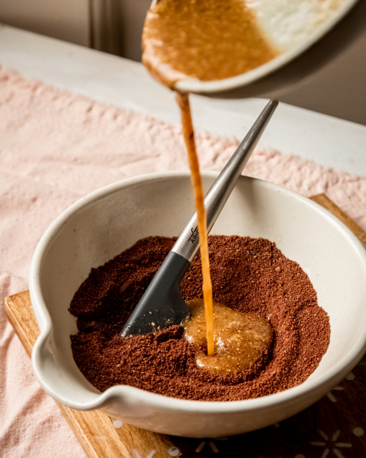 A 3/4 angle image shows wet ingredients being added to dry ingredients for a cookie recipe.