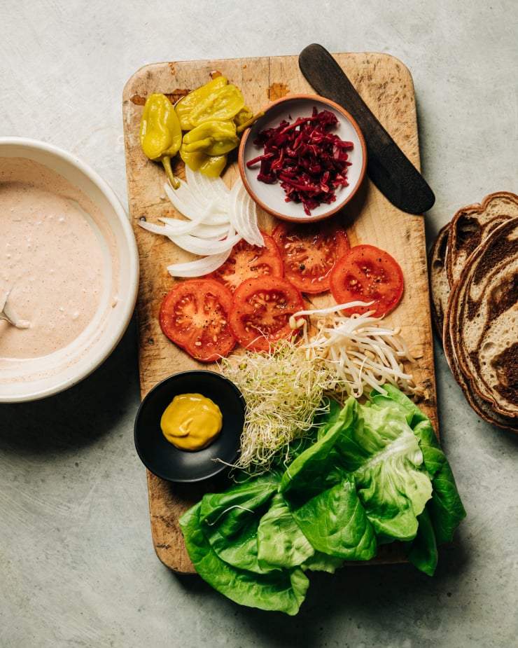 An overhead shot of ingredients prepped to make a vegan veggie crunch sandwich.