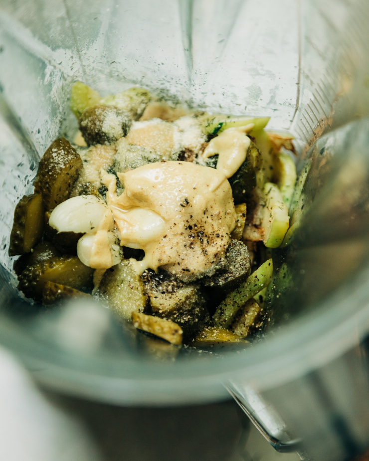 An overhead image shows ingredients in a blender that will be turned into a dip.