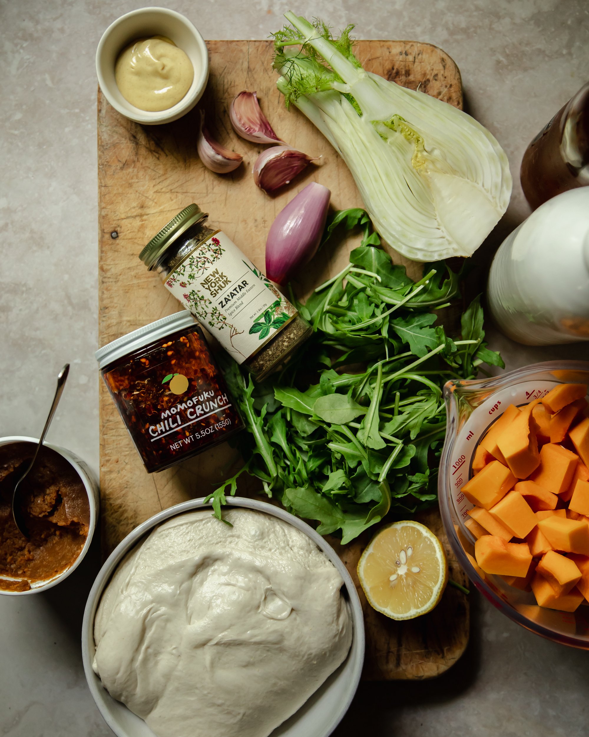 An overhead shot of ingredients used for a vegan butternut squash flatbread dinner.
