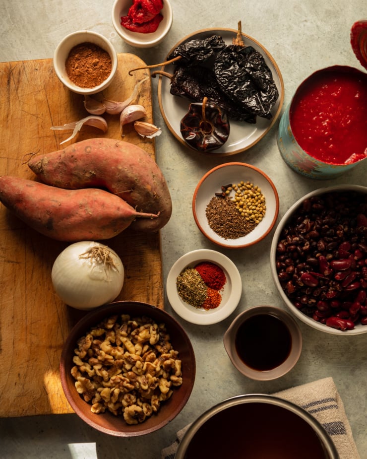 An overhead shot shows ingredients used in a vegan sweet potato walnut chili.