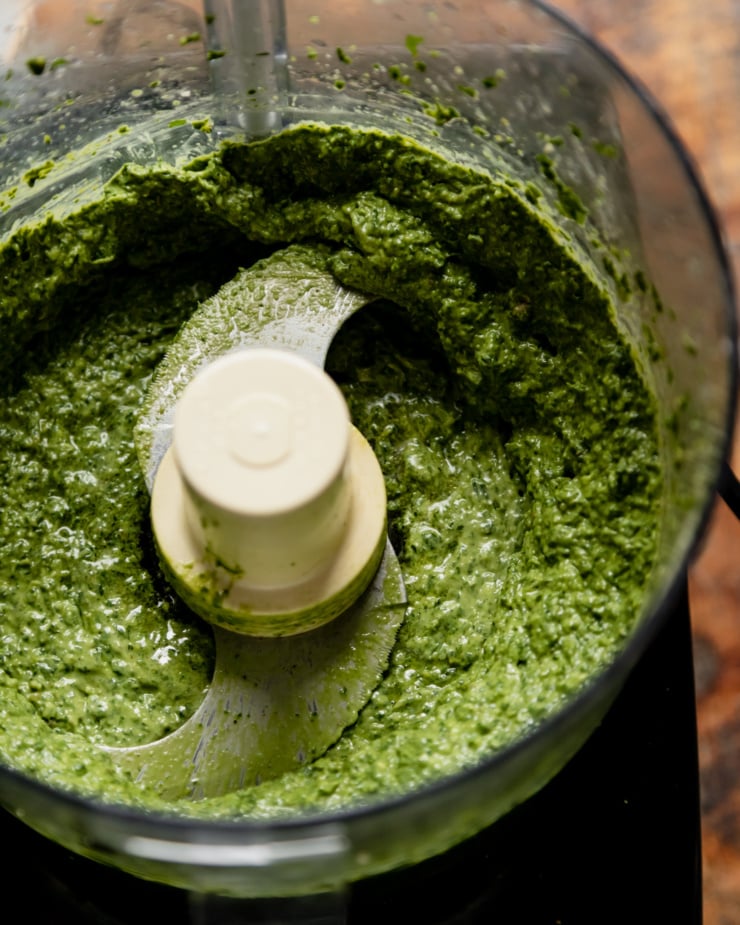 An overhead shot of vegan pesto after being freshly mixed up in a food processor.