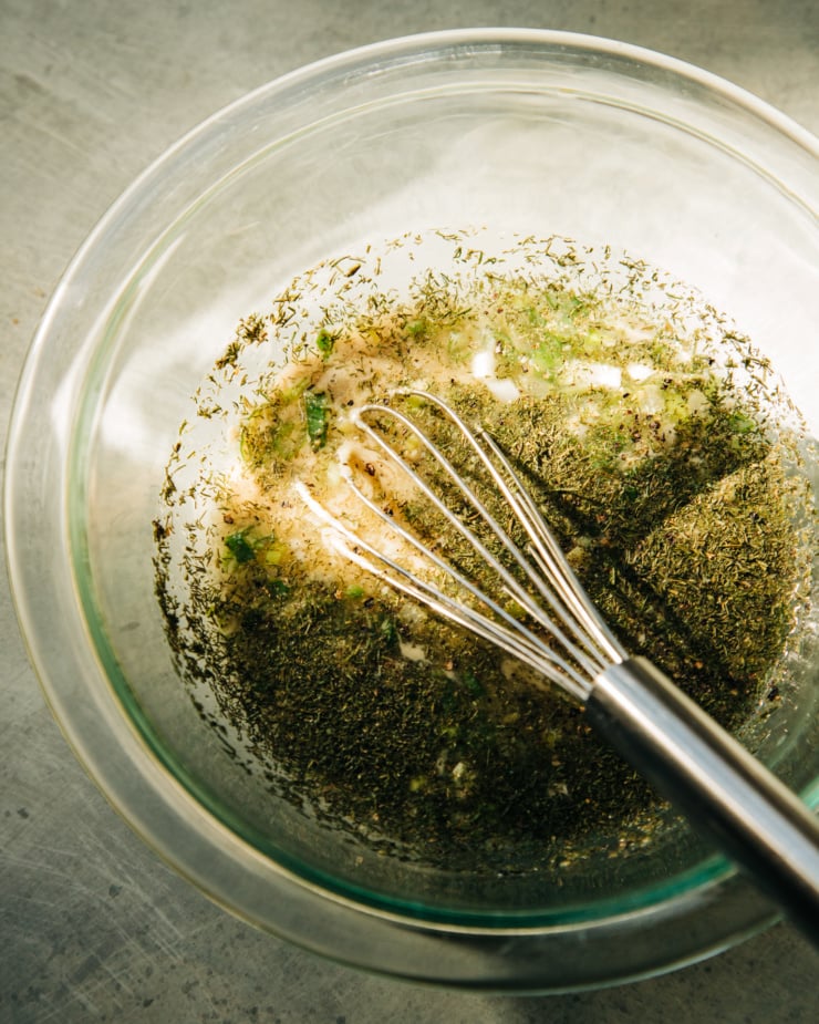 An overhead shot shows ingredients for a tahini ranch dressing before being whisked together.