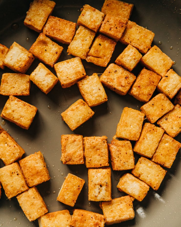 An up close, overhead shot of browned, spiced tofu cubes.