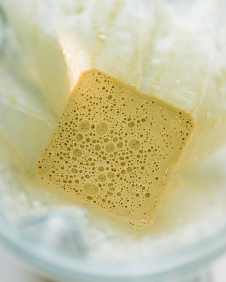 An overhead shot of a creamy, blended up dill dressing for a chopped creamy dill pickle salad.