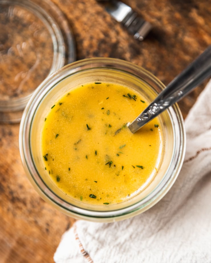 An overhead shot of a red wine vinegar and thyme dressing.