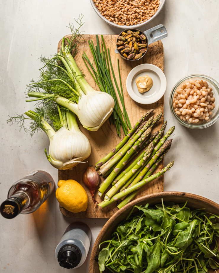 An overhead shot shows ingredients used in a lemony shaved fennel asparagus salad.