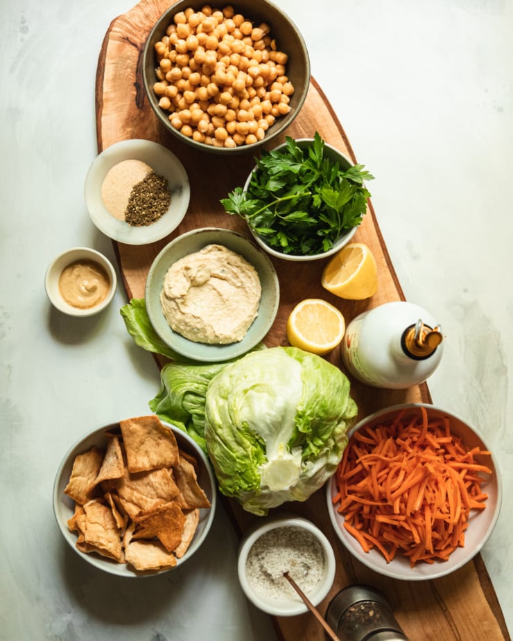 An overhead shot shows ingredients used in a hummus crunch salad.