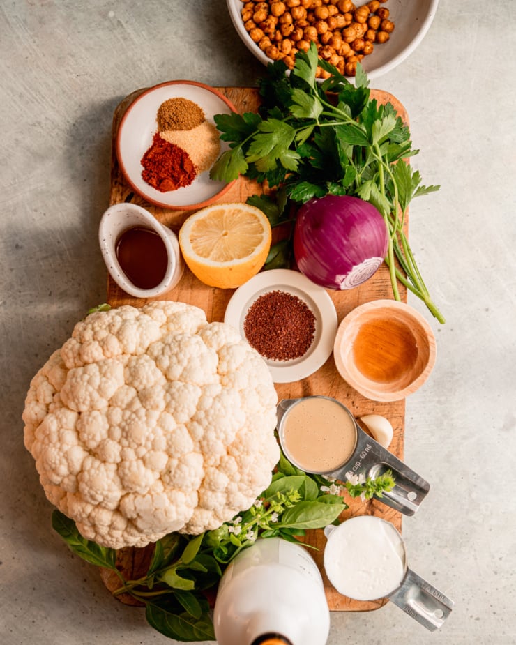 An overhead shot of some ingredients for a vegan BBQ main on a worn wood cutting board.