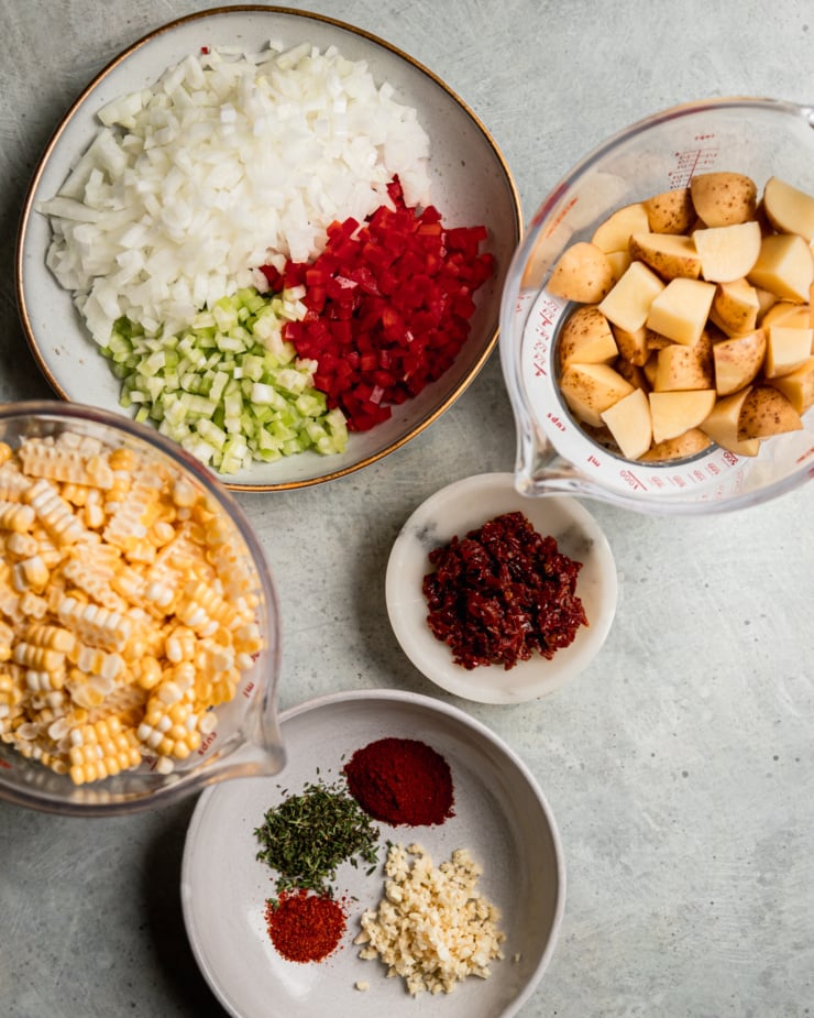 An overhead shot shows prepped and chopped ingredients for a soup.