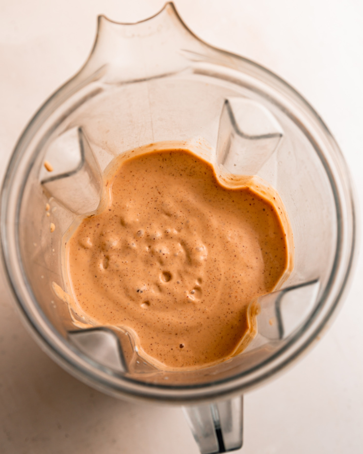 An overhead shot of a smoothie blended up in a blender jug.