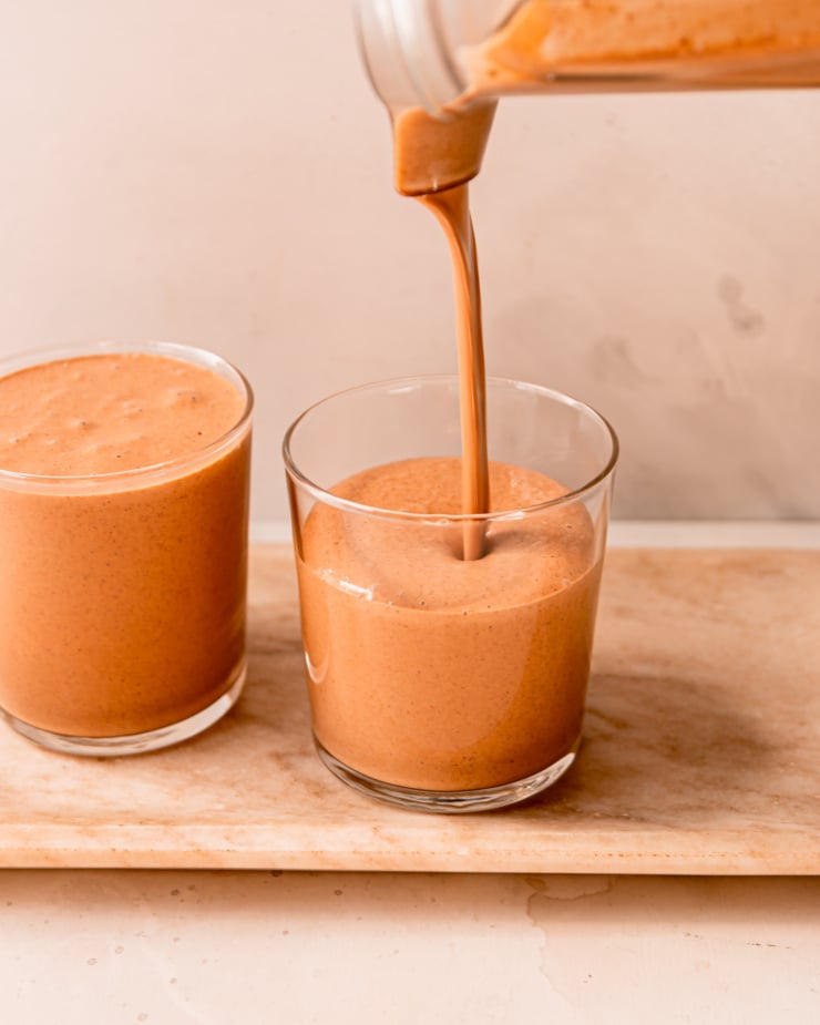 A head-on shot shows a smoothie being poured into a glass.