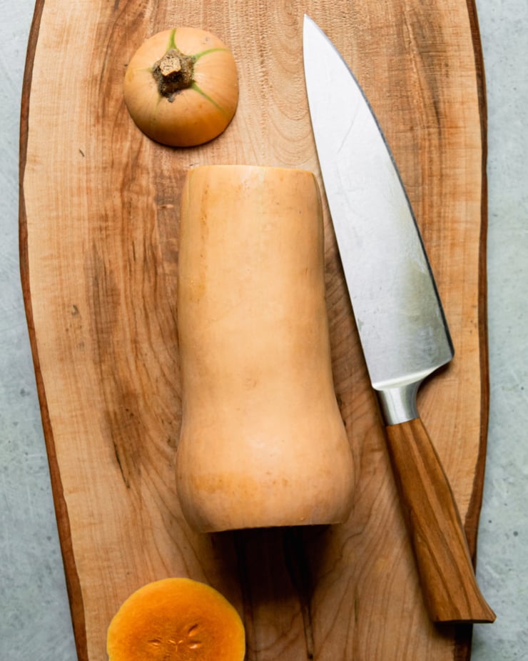 An overhead shot shows a butternut squash with the top and bottom sliced off and a knife nearby