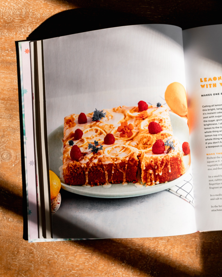 An overhead shot shows a photo of a lemony cake in the book "Plantcakes" by Lyndsay Sung.