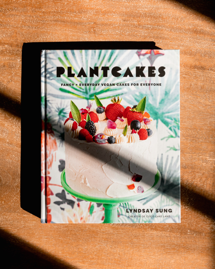 An overhead shot shows the cover of the cookbook "Plantcakes" by Lyndsay Sung.