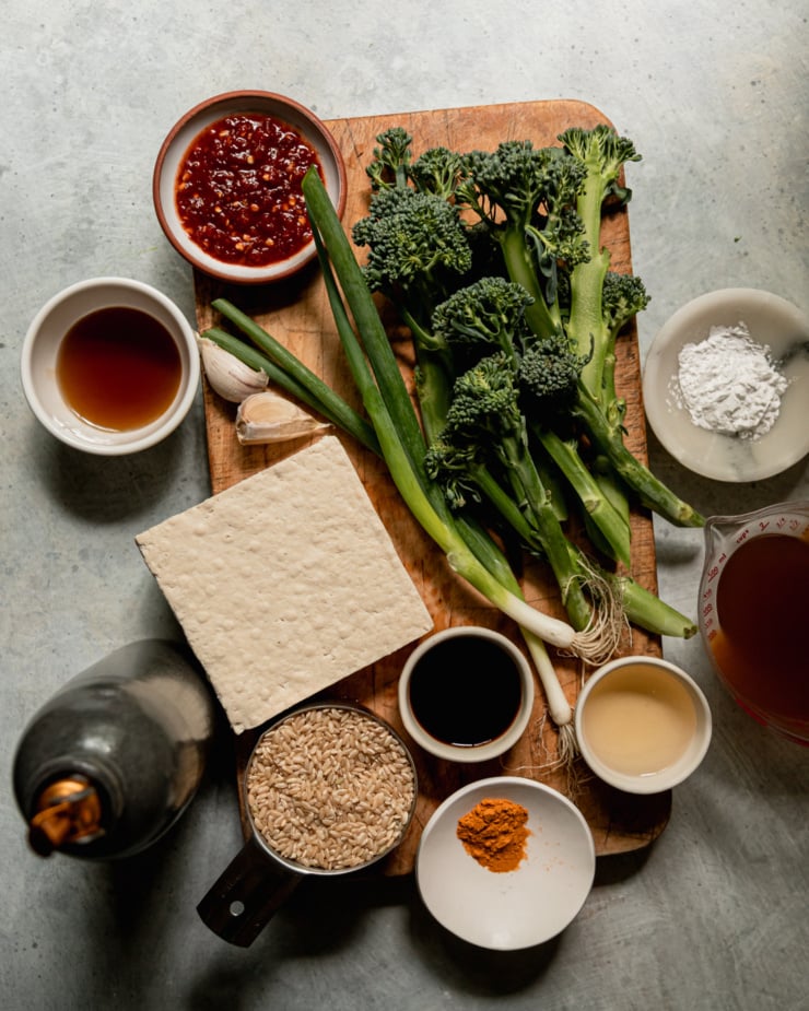An overhead shot shows ingredients for a spicy maple tofu bowls recipe,