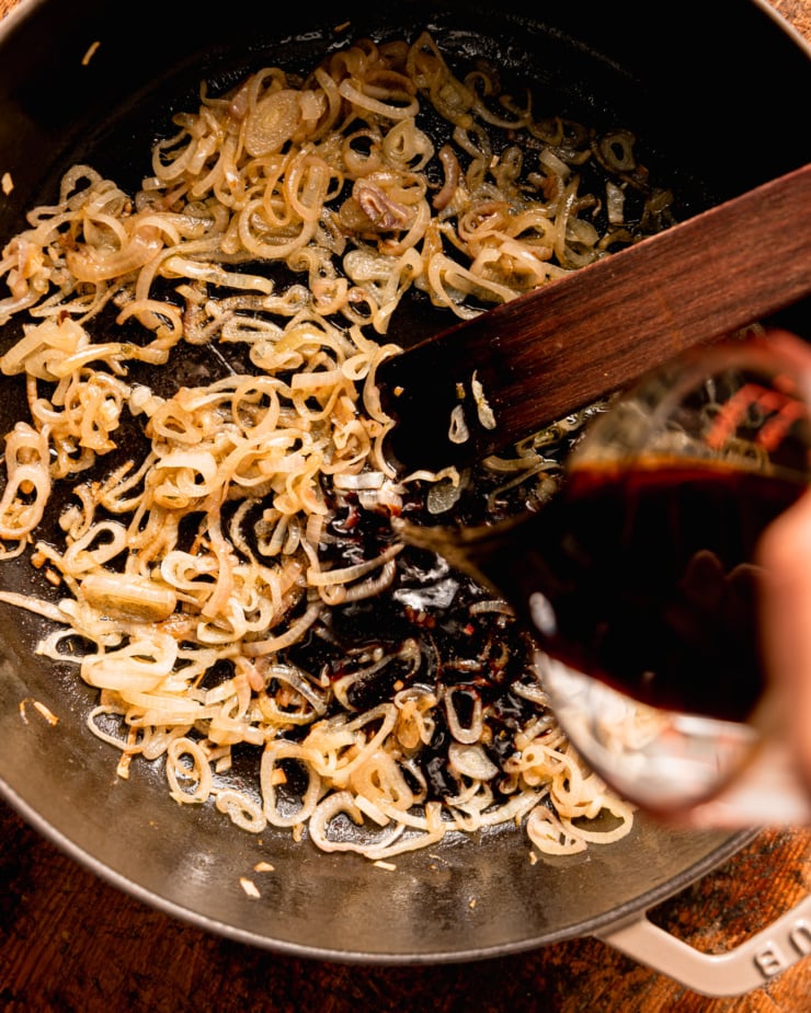 An overhead shot shows a pot with sautéed shallots and balsamic vinegar being poured in.