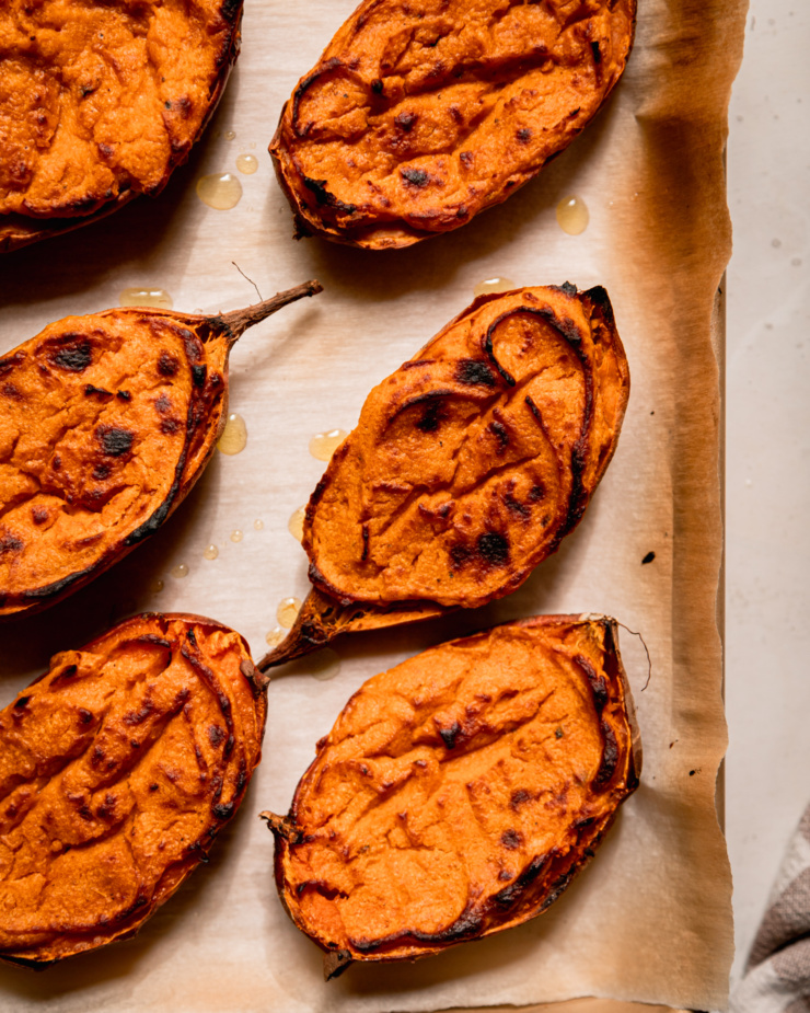 An overhead shot shows twice baked sweet potato halves that have been flavoured with chili and lime.