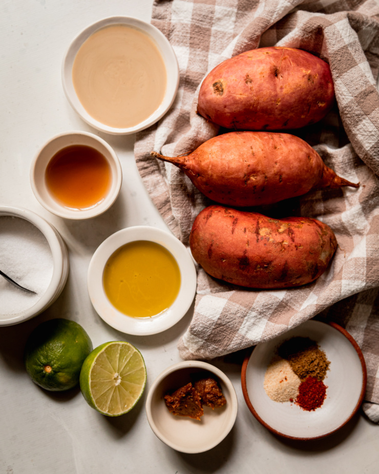 An overhead shot shows ingredients for vegan twice baked sweet potatoes.