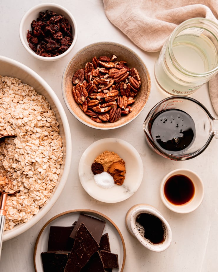 An overhead shot shows ingredients for a vegan ginger molasses granola recipe; all prepped and measured.
