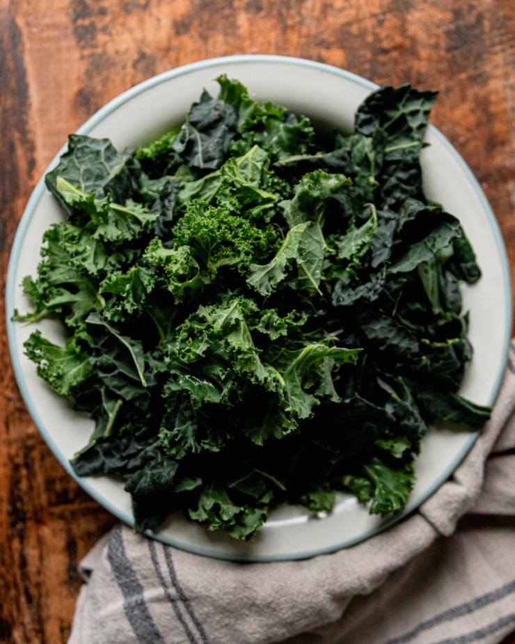 An overhead shot shows a bowl of chopped kale.