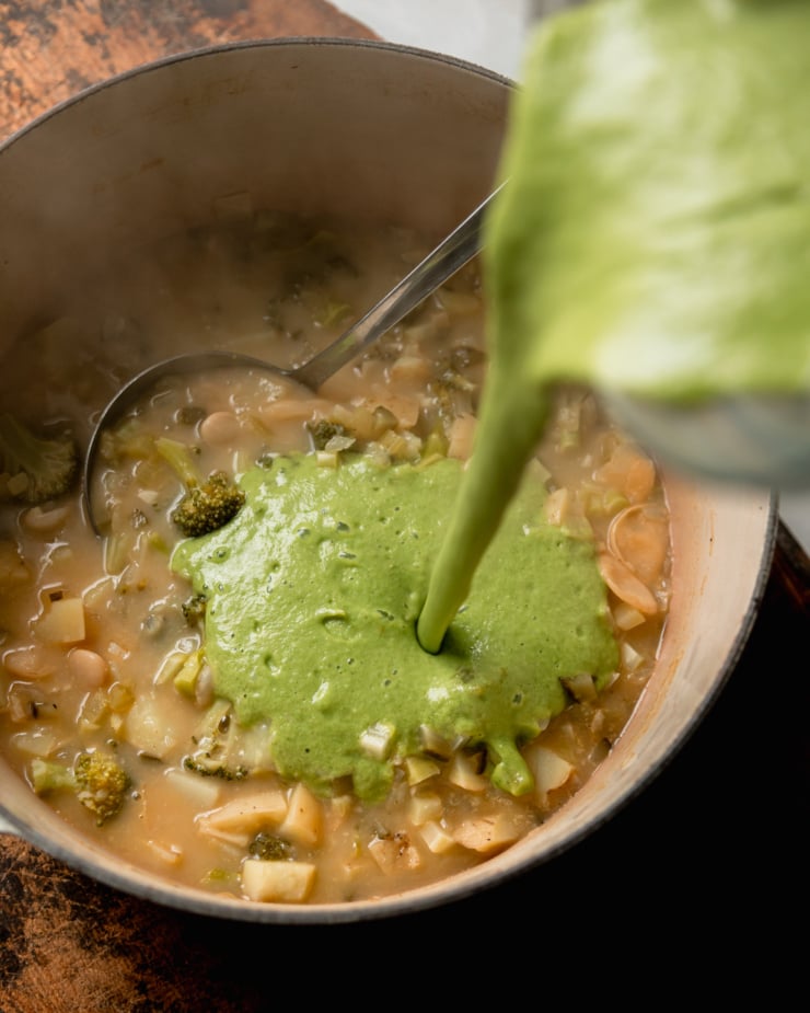 An overhead shot shows a green purée being poured into a pot of coup.