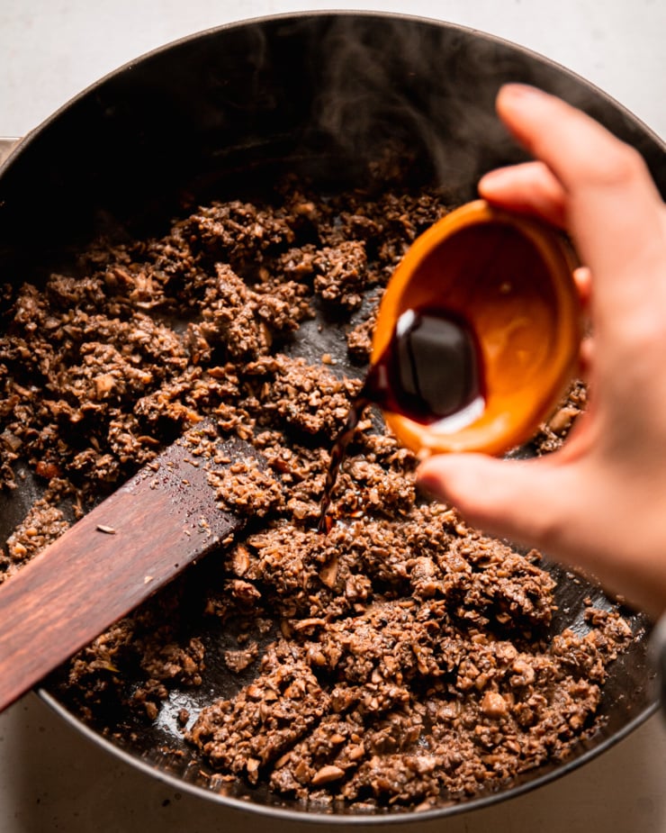 An overhead shot shows Tamari being poured into a pot with mushroom duxelles.